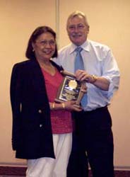 Monina Regitko receiving a special appreciation award from Charles Moore, President of the C.N.A.